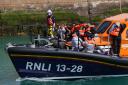 Asylum seekers being brought into port by the RNLI  after their perilous small boat crossing via the Channel