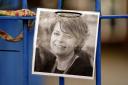A photo of Ruth Perry attached to the fence outside John Rankin Schools in Newbury, Berkshire (Andrew MAtthews/PA)