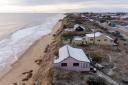 Homes close to the cliff edge at Hemsby in Norfolk, pictured in March 2023, months before the road collapse. (Joe Giddens/ PA)