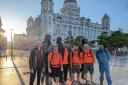 Challenge - Jake Quickenden (centre) and Chris Metcalfe (third right) at the start of their walk in Liverpool