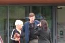 Joshua Joyce leaves court with his grandmother and defence solicitor, Philippa Beswick, in August