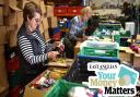 Foodbank bosses in Suffolk say donations are falling as the cost-of-living crisis continues to hit families. Pictured: Volunteers sorting donations at a foodbank in 2017.