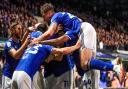 Town players celebrate with a hidden Lee Evans after his hat-trick in Ipswich Town's 6-0 win over Doncaster Rovers