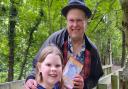 David Howden with his daughter Katelyn on the bridge at East Town Park, in Haverhill, which is illustrated in Mr Howden's latest book.