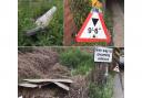 Debris from numerous crashes into the bridge has been left on the sides of the road