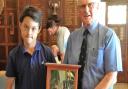 Thirteen-year-old Dominic Rudd receives the Silver Frigate from Thorpeness club captain Robin Leggate. Photograph: CONTRIBUTED