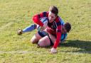 Stowmarket's Tom Crewe touches down, despite the best efforts of JP Hart, in their win over Woodbridge in the Chadacre Cup semi-final. Picture: SIMON BALLARD