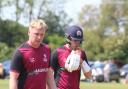 Dan Shanks, left, and Tom Harper, right, leave the pitch after their unbroken partnership of 45 boosted Suffolk to a match-winning total of 206 for 8 against Norfolk at Horsford CC last Sunday. Picture: NICK GARNHAM