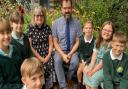 Headteacher Jeremy Leicester and Rev Canon Susan Loxton alongside pupils