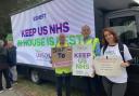 Tracy Lavery, Mark Woodugle and Natalia Junusz all with signs