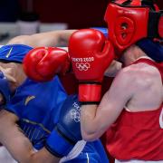 Britain's Charley-Sian Davison, right, exchanges punches with China's Chang Yuan during their women's flyweight 51-kg boxing match at the 2020 Summer Olympics, Thursday, July 29, 2021, in Tokyo, Japan.