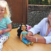 Jasmine with teddy 'Buzzy' and teddy doctor Vanessa Crawford at the annual flower festival and teddy bear parachuting bonanza in Blundeston.