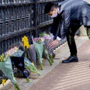 A member of the public leaves flowers outside Buckingham Palace, London, following the announcement of the death of the Duke of Edinburgh at the age of 99.