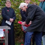 Veteran Percy King, aged 91, laying a wreath at the rededication service for Trimley St Mary's memorial bench