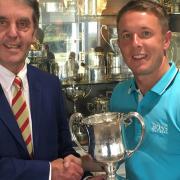 Danny Western of Gorleston receives the Seaton Robson Trophy from Aldeburgh vice-captain Antony Dearden. Western did the double winning both the gross and handicap competitions. Picture: CONTRIBUTED