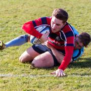 Stowmarket's Tom Crewe touches down, despite the best efforts of JP Hart, in their win over Woodbridge in the Chadacre Cup semi-final. Picture: SIMON BALLARD