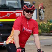Firefighter Simon Lewis gets on his bike for the Suffolk Fire Ride