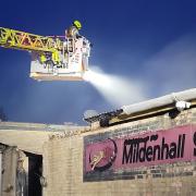 Firefighters remain at Mildenhall Stadium after a fire broke out