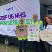 Tracy Lavery, Mark Woodugle and Natalia Junusz all with signs