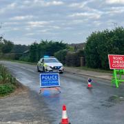 Police have closed the road after an oil spillage