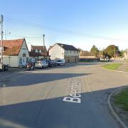 A road in a Suffolk village has been closed as crews tackle a fire at a hairdresser.