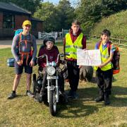 William, Owen and Connor with Aiden, who completed a Duke of Edinburgh expedition on an all-terrain mobility scooter donated by a local firm