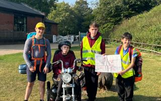 William, Owen and Connor with Aiden, who completed a Duke of Edinburgh expedition on an all-terrain mobility scooter donated by a local firm