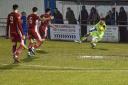 Felixstowe & Walton United goalkeeper Josh Blunkell makes a vital save from Leiston striker Jamar Loza (blue shirt, No.11) in the Seasiders’ 2-1 semi-final victory at Ipswich Wanderers FC. Image: Paul Voller