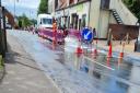 A photograph showing the burst water main on The Street in Acle