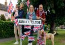 Jubilee Close in Laxfield, one of the most patriotic roads in the county, and celebrating the weekend are George Ryan holding India, Wizzo and Alex Denholme but not forgetting a very patriotic Scooter