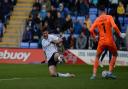 Cameron Burgess flings himself into a challenge on the Shrewsbury keeper and earns himself a red card at Shrewsbury.