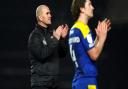 AFC Wimbledon manager Mark Robinson (left) applauds fans.