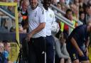 The two managers are all smiles again after a little altercation on the touchline which resulted in Paul Cook being shown a yellow card at Burton Albion.