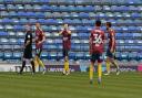 Gwion Edwards covers his face in disbelief at the officials decision leading to the Portsmouth winner