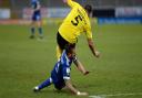 Luke Chambers slides underneath Michael Bostwick at Burton Albion and gets booked for it. Picture Pagepix Ltd