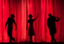 People on stage in a theatre.