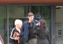 Joshua Joyce leaves court with his grandmother and defence solicitor, Philippa Beswick, in August