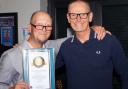 Dean Gould with his Record Holders Republic special achievement award to mark 40 years of record breaking and councillor Seamus Bennett, who presented the award on behalf of the US RHR.