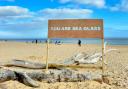 The artwork 'You are sea glass' created on Southwold beach by Adam Bridgland