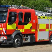 Five fire crews have been called to help a woman stuck in mud near East Bergholt.