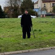 Adam Robertson, a member of Residents Against Noise and Speed (RANS) in Kessingland, looks over at a damaged sign on the roundabout south of Jaydene Caravan Park.