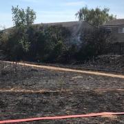 Firefighters have worked quickly to stop a fire from spreading to homes