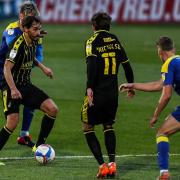 Ed Upson (left) in action during the Sky Bet League One match at the Plough Lane, London, against Wimbledon. He has joined Stowmarket Town in Isthmian North.