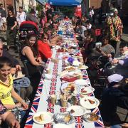 Bathed in sunshine, they got together for a big game of pass the parcel as part of the celebrations Picture: ADAM HOWLETT