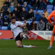 Cameron Burgess flings himself into a challenge on the Shrewsbury keeper and earns himself a red card at Shrewsbury.