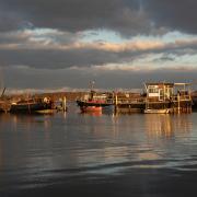 The sun sets on the water at Pin Mill.