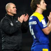 AFC Wimbledon manager Mark Robinson (left) applauds fans.