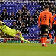 Christian Walton saves an Oldham Athletic penalty, taken by Dylan Bahamboula.