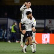 Ipswich Lee Evans and Macauley Bonne players celebrate the 4-1 win on the final whistle at Adams Park.