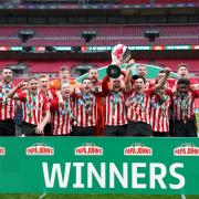 Sunderland players celebrate with the Papa John's Trophy after the 2021 final at Wembley Stadium on Sunday.